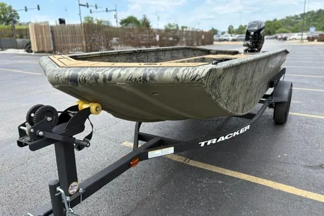 Slide: The Image of 2026 Tracker Grizzly 1650 T Prairie Wings Edition boat on trailer in parking lot. - 5