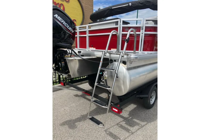 Slide: The Image of 2026 Sun Tracker SportFish 20 DLX pontoon boat with ladder and Mercury engine. - 3