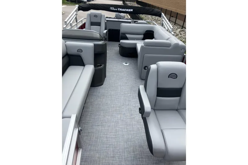 Slide: The Image of 2026 Sun Tracker SportFish 20 DLX pontoon boat interior with gray seating and carpet. - 7