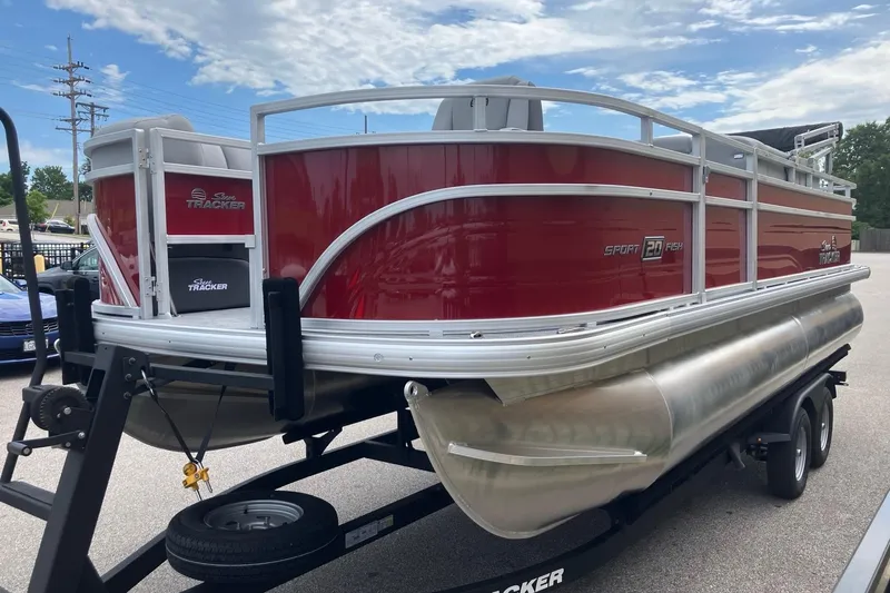 Slide: The Image of 2026 Sun Tracker SportFish 20 DLX pontoon boat on trailer, red and silver design. - 6