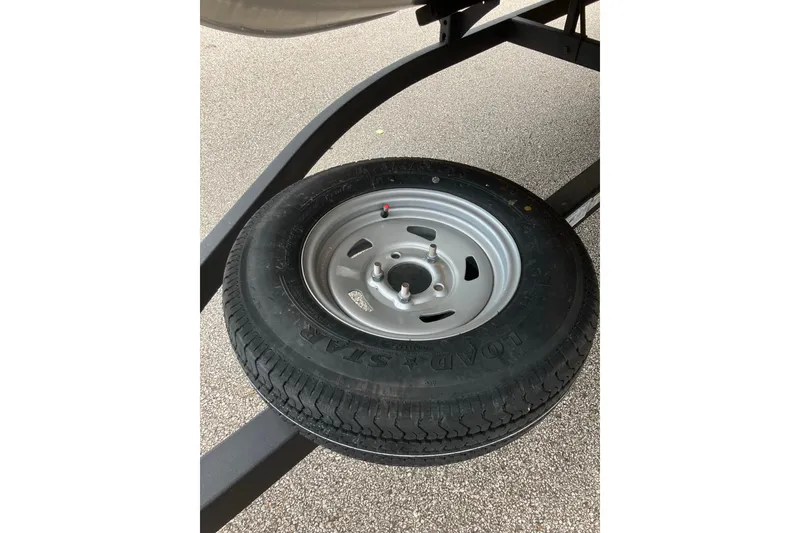 Slide: The Image of Spare tire mounted on a Sun Tracker SportFish 20 DLX trailer, 2026 model. - 5