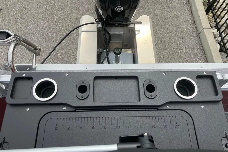 Slide: The Image of Control panel of 2026 Sun Tracker SportFish 20 DLX boat with cup holders and ruler. - 14