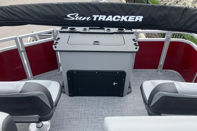 Slide: The Image of 2026 Sun Tracker SportFish 20 DLX pontoon boat interior with seating and storage. - 12