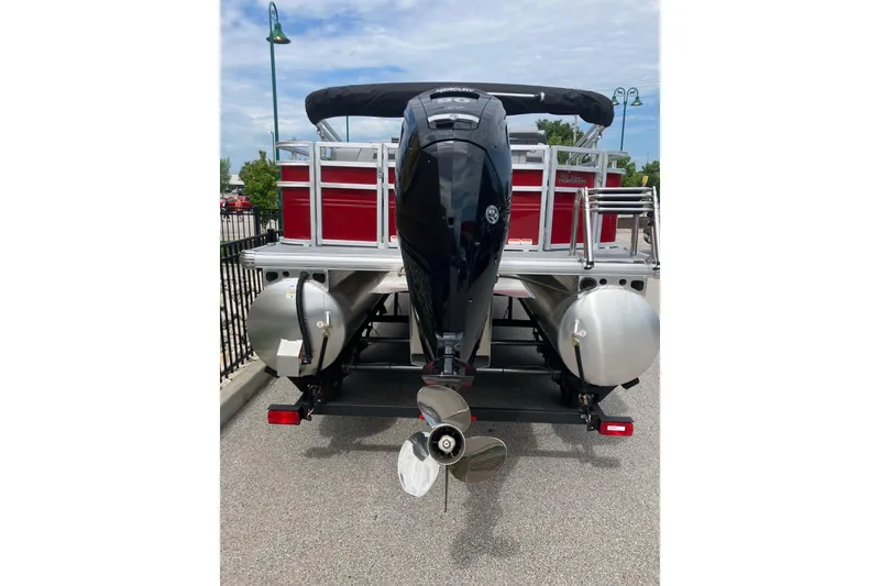 Slide: The Image of 2026 Sun Tracker SportFish 20 DLX pontoon boat rear view with outboard motor. - 2