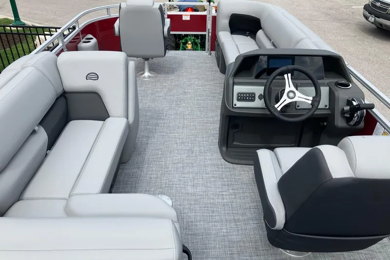Slide: The Image of 2026 Sun Tracker SportFish 20 DLX pontoon boat interior with plush seating and modern helm. - 11