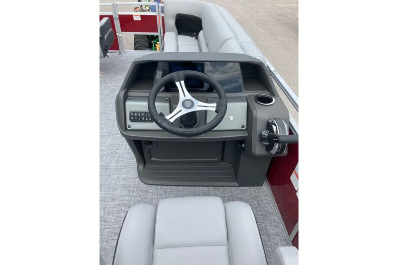 Slide: The Image of 2026 Sun Tracker SportFish 20 DLX boat console with steering wheel and controls. - 8