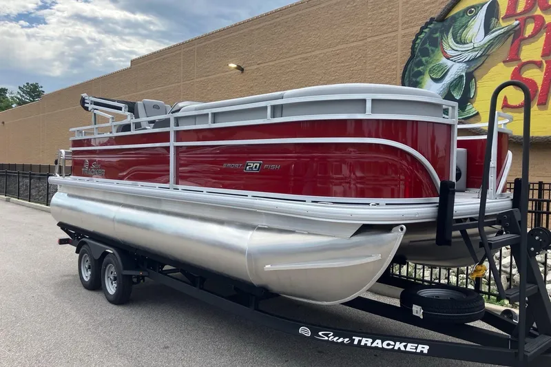 Slide: The Image of 2026 Sun Tracker SportFish 20 DLX pontoon boat on trailer, parked outdoors. - 4