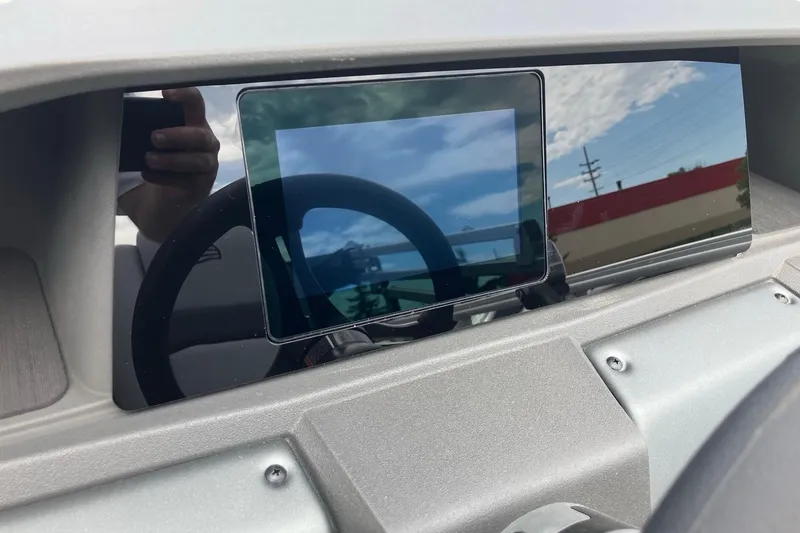 Slide: The Image of Dashboard of 2026 Sun Tracker SportFish 20 DLX with digital display and steering wheel. - 9