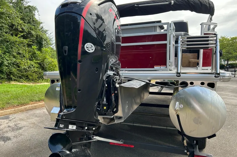 Slide: The Image of 2026 Sun Tracker SportFish 20 DLX pontoon boat with powerful outboard motor. - 2