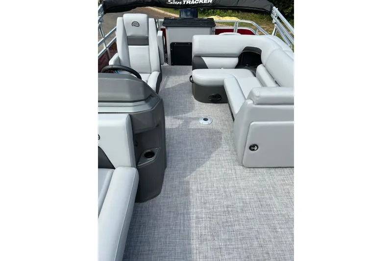 Slide: The Image of 2026 Sun Tracker SportFish 20 DLX pontoon boat interior with gray seating and carpet. - 3