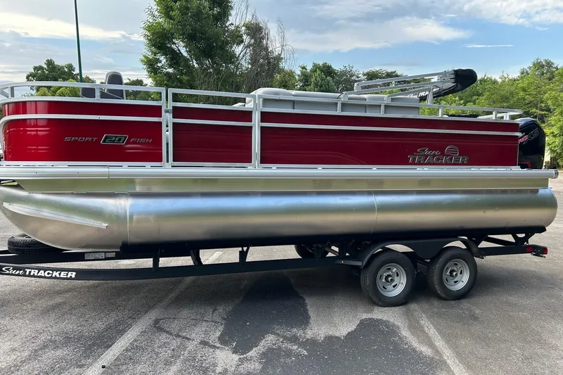 Slide: The Image of 2026 Sun Tracker SportFish 20 DLX pontoon boat on trailer, parked outdoors. - 4