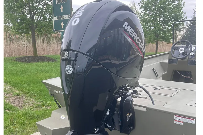 Slide: The Image of 2026 Tracker Grizzly 2072 CC boat with Mercury 150 outboard motor, parked outdoors. - 4
