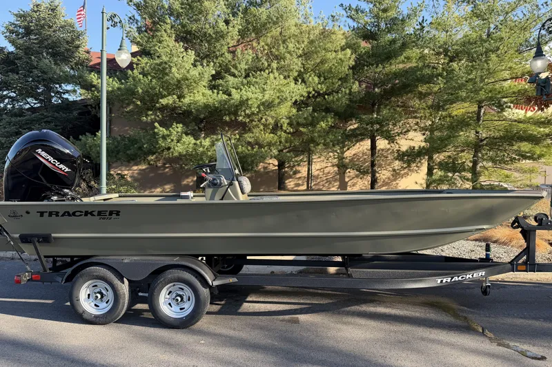 The Image of 2026 Tracker Grizzly 2072 CC boat on trailer, parked outdoors near trees. - 0