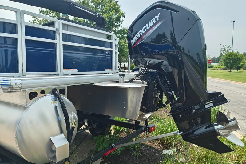 Slide: The Image of 2026 Sun Tracker SportFish 20 DLX pontoon boat with Mercury outboard motor. - 5