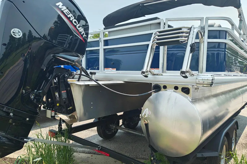 Slide: The Image of 2026 Sun Tracker SportFish 20 DLX pontoon boat with Mercury outboard motor. - 6