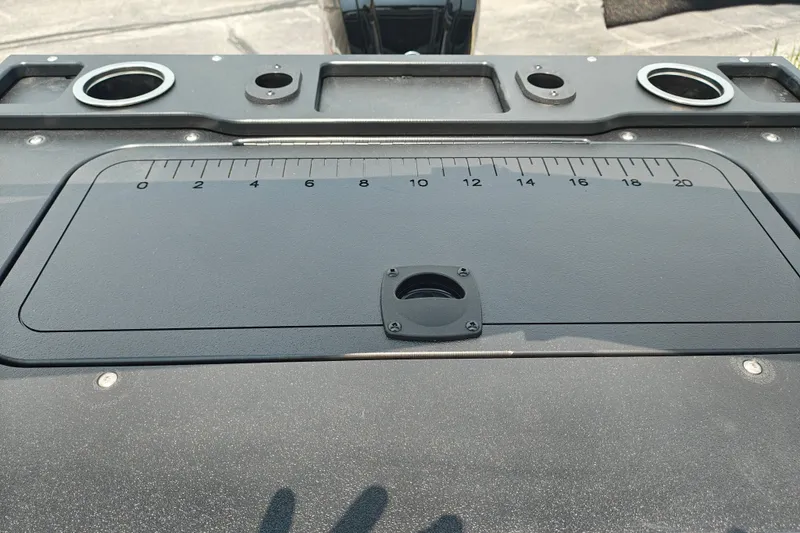 Slide: The Image of 2026 Sun Tracker SportFish 20 DLX boat dashboard with measurement markings and cup holders. - 21