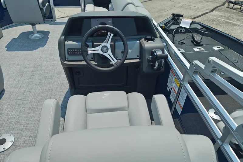 Slide: The Image of 2026 Sun Tracker SportFish 20 DLX boat interior with steering wheel and seating. - 16