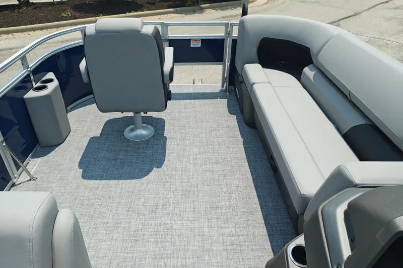 Slide: The Image of 2026 Sun Tracker SportFish 20 DLX pontoon boat interior with gray seating and carpet. - 26