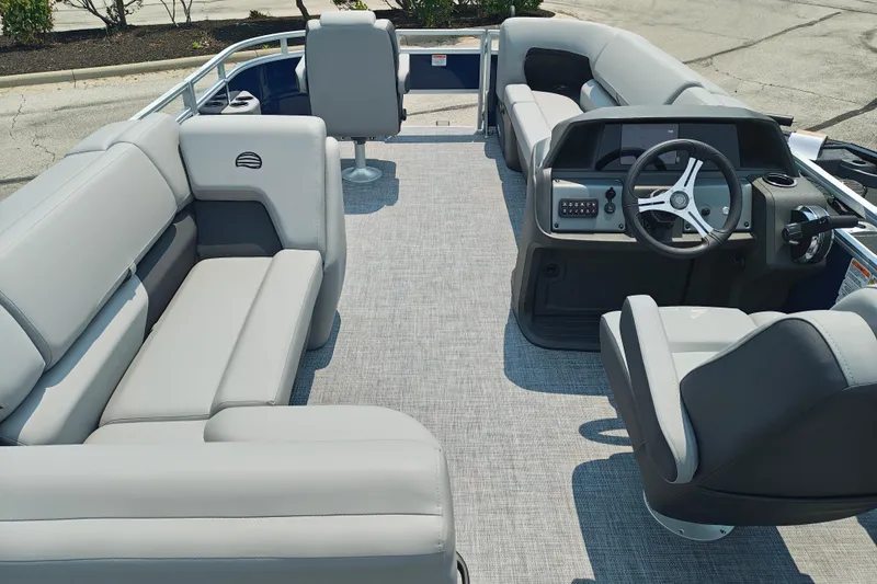 Slide: The Image of 2026 Sun Tracker SportFish 20 DLX pontoon boat interior with plush seating and modern helm. - 23