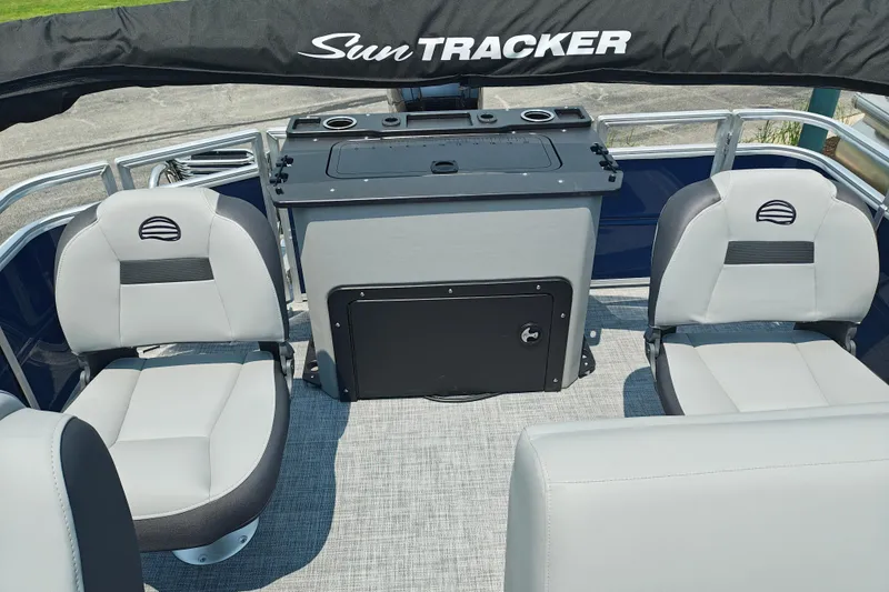 Slide: The Image of 2026 Sun Tracker SportFish 20 DLX interior with seating and storage console. - 20