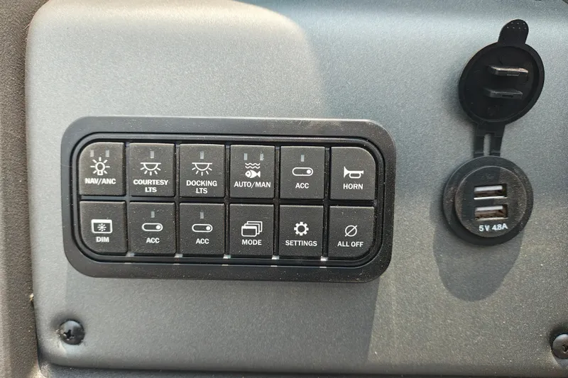Slide: The Image of Control panel of 2026 Sun Tracker SportFish 20 DLX with various switches and USB ports. - 18