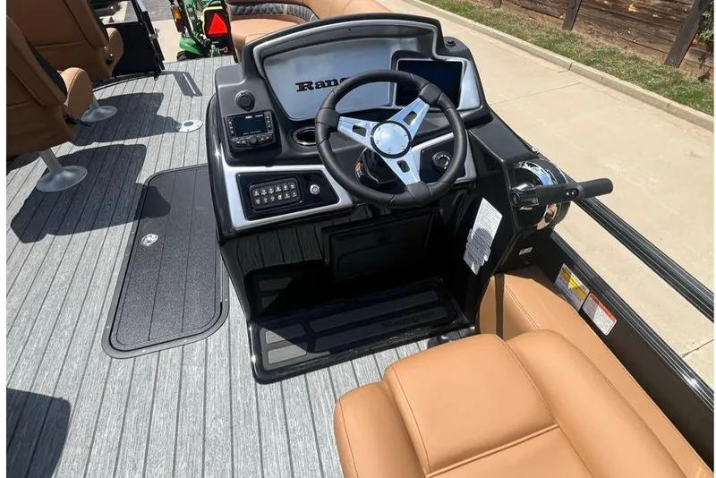 Slide: The Image of 2026 Ranger 223FC boat interior with steering wheel and control panel. - 2