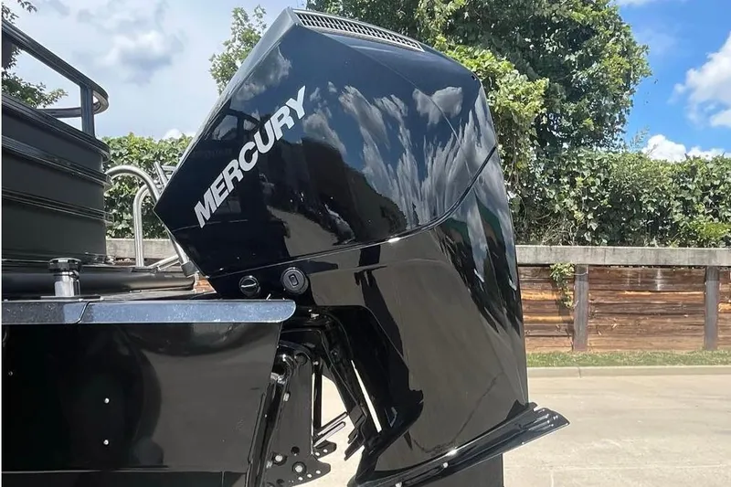 Slide: The Image of Mercury outboard motor on 2026 Ranger 223FC boat, outdoors with greenery background. - 3