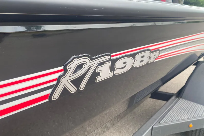 Slide: The Image of 2026 Ranger RT198P boat with red and white stripes on the side. - 2