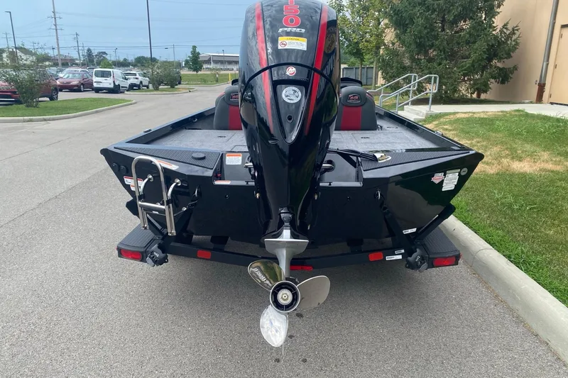 Slide: The Image of 2026 Ranger RT198P boat with powerful outboard motor, parked on a street. - 7