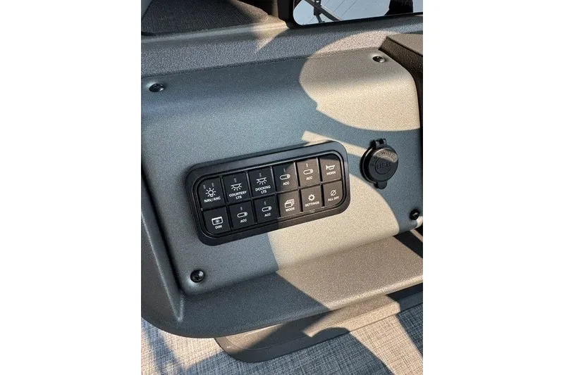 Slide: The Image of Control panel of 2026 Sun Tracker Party Barge 20 DLX with various switches. - 14