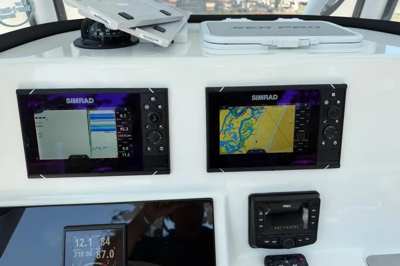 Slide: The Image of Simrad navigation displays on 2021 Sea Pro 248 Bay boat dashboard. - 28