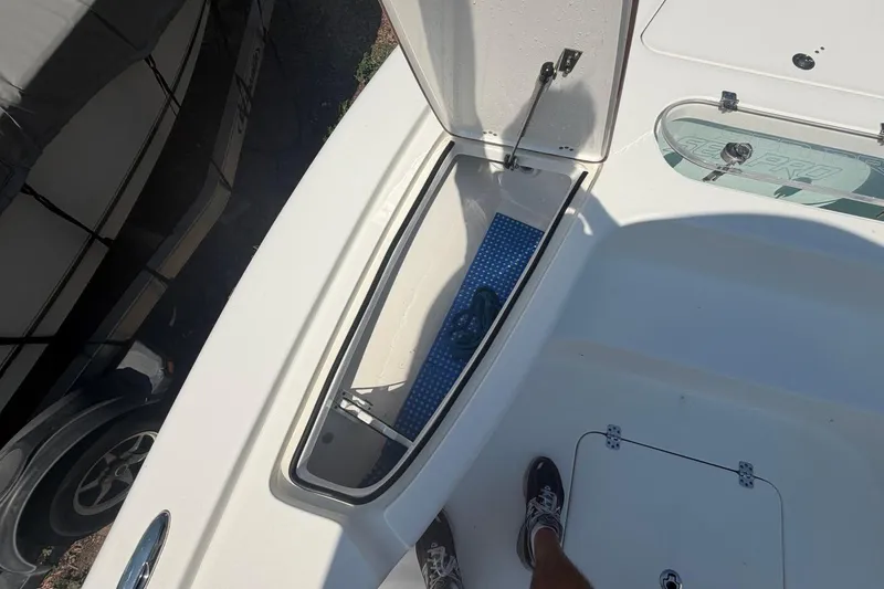 Slide: The Image of 2021 Sea Pro 248 Bay boat deck with open storage compartment. - 34
