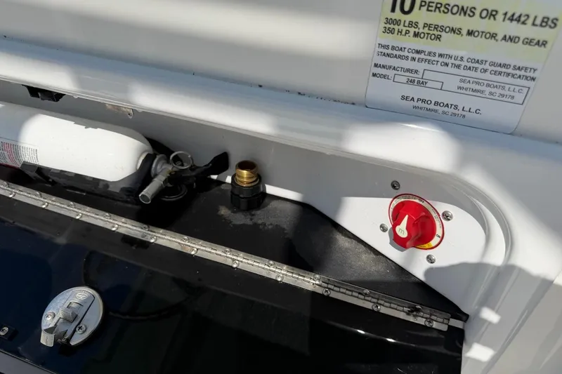 Slide: The Image of 2021 Sea Pro 248 Bay boat control panel with safety label and fire extinguisher. - 21