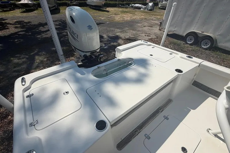 Slide: The Image of 2021 Sea Pro 248 Bay boat with Suzuki 200 outboard motor, featuring spacious deck layout. - 16