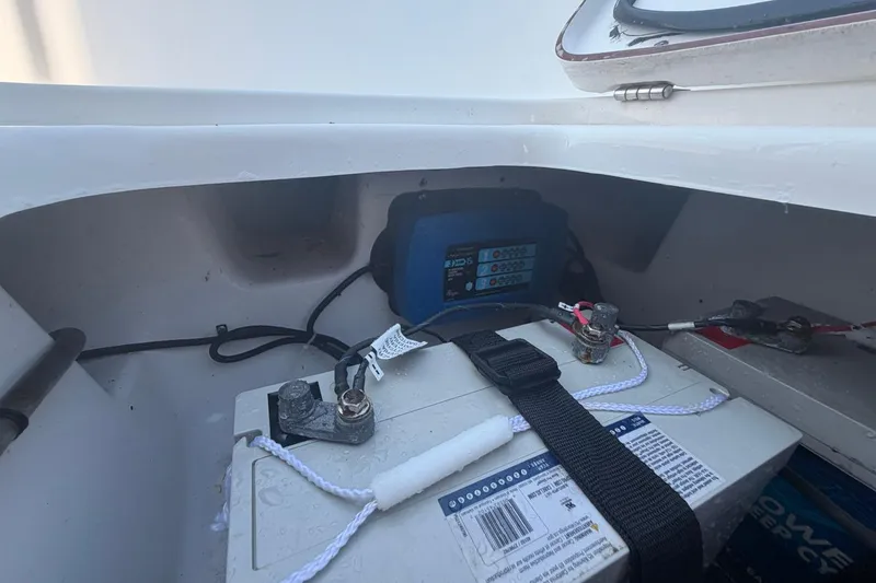 Slide: The Image of Battery compartment of a 2021 Sea Pro 248 Bay boat, showing wiring and connections. - 33
