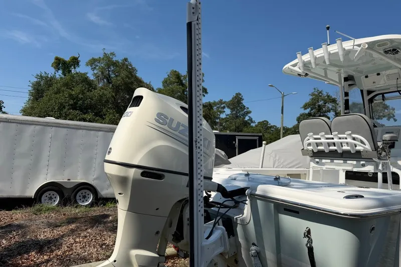 Slide: The Image of 2021 Sea Pro 248 Bay boat with Suzuki outboard motor, parked outdoors. - 5