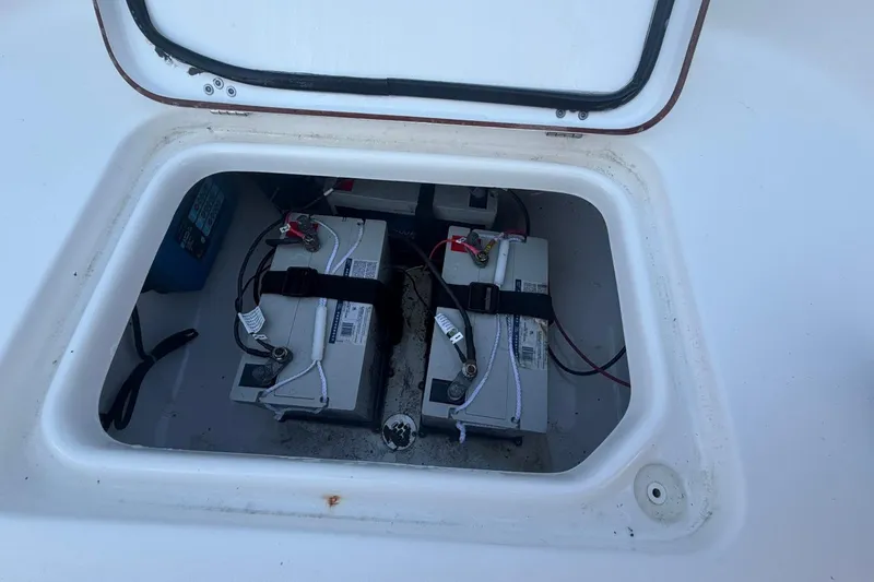 Slide: The Image of Battery compartment of a 2021 Sea Pro 248 Bay boat, showing dual batteries. - 32