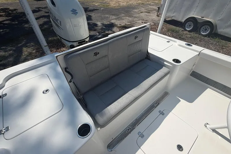 Slide: The Image of 2021 Sea Pro 248 Bay boat interior with gray seating and Suzuki 200 outboard motor. - 18