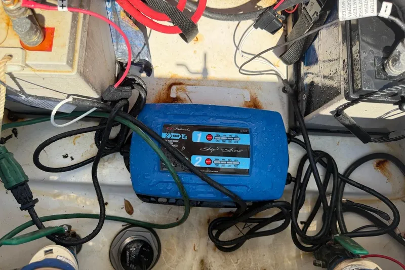 Slide: The Image of Boat battery charger setup in a 2021 Sea Pro 248 Bay. - 24