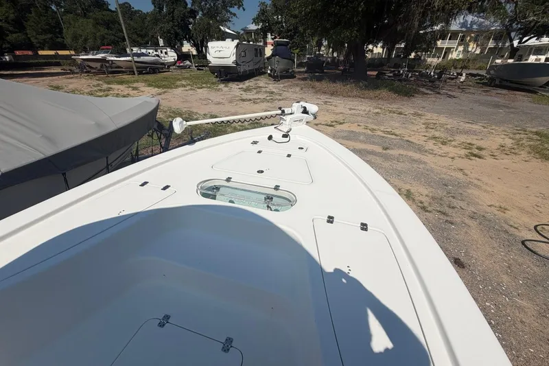 Slide: The Image of 2021 Sea Pro 248 Bay boat on land, showcasing deck and storage compartments. - 31