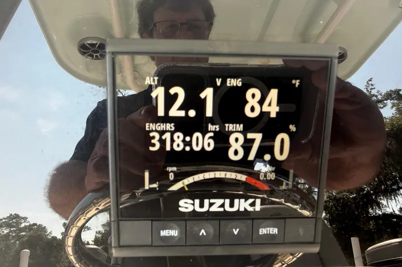 Slide: The Image of Display screen on a 2021 Sea Pro 248 Bay boat showing engine metrics. - 13