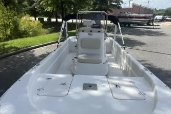 Slide: The Image of 2014 Carolina Skiff JVX18CC boat with center console, parked outdoors on a sunny day. - 1