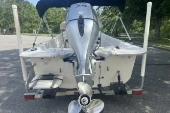Slide: The Image of 2014 Carolina Skiff JVX18CC boat with outboard motor, parked on a trailer. - 7