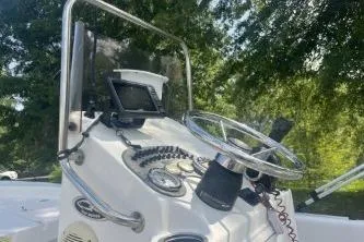Slide: The Image of 2014 Carolina Skiff JVX18CC boat console with steering wheel and navigation equipment. - 4