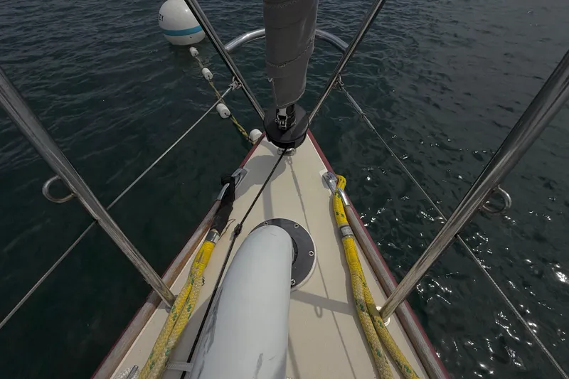 Slide: The Image of Bow view of 2006 J Boats J/100 sailboat with mooring lines and calm water. - 14