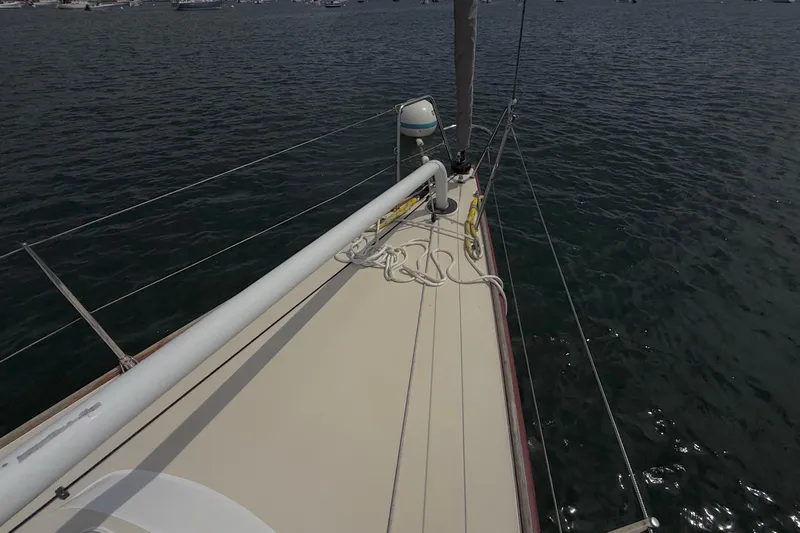 Slide: The Image of 2006 J Boats J/100 sailboat deck with ropes, moored on calm water. - 13