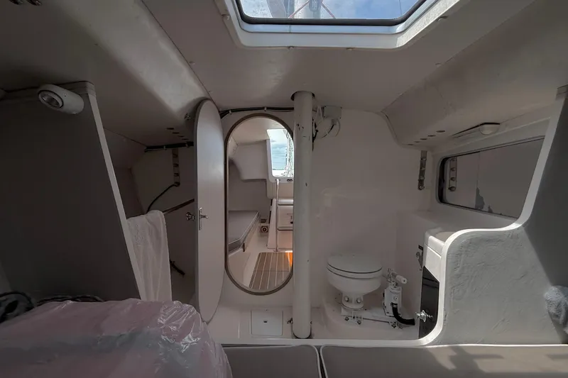 Slide: The Image of Interior of 2006 J Boats J/100 sailboat, featuring compact cabin and marine toilet. - 24