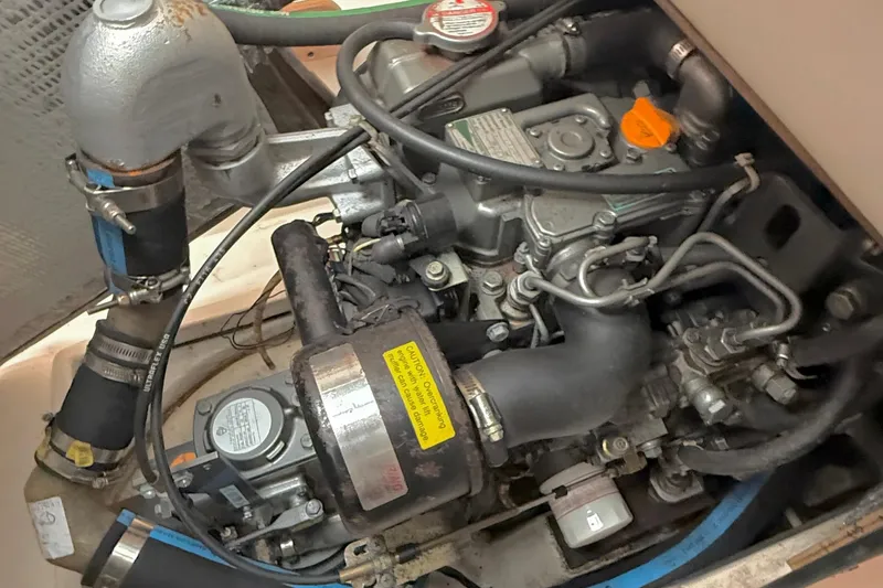 Slide: The Image of Engine compartment of a 2006 J Boats J/100 sailboat, showcasing mechanical components and hoses. - 27