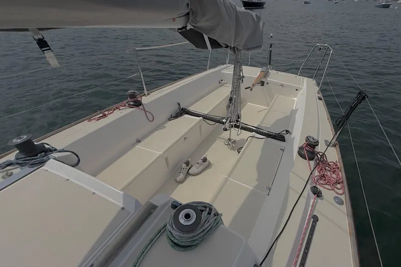 Slide: The Image of 2006 J Boats J/100 sailboat cockpit with ropes and winches on calm water. - 18