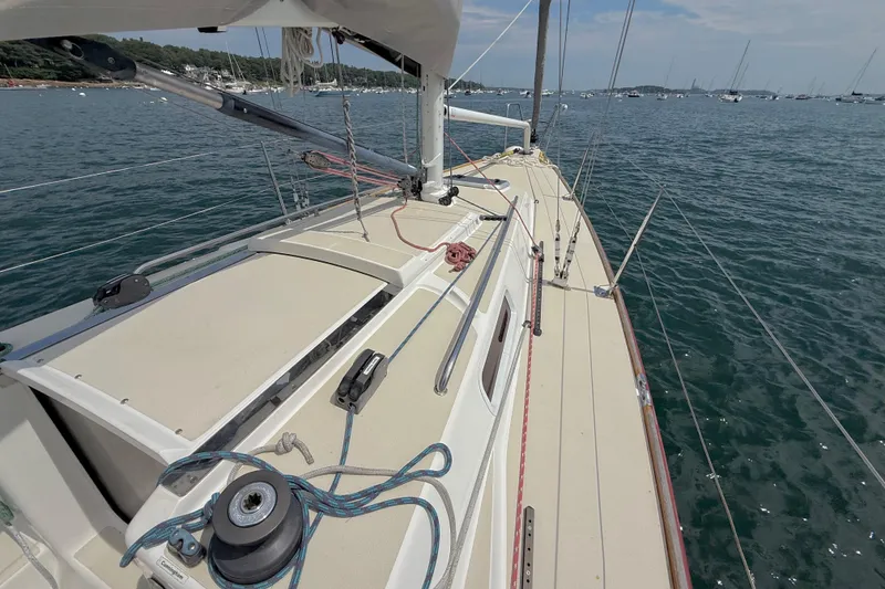 Slide: The Image of 2006 J Boats J/100 sailboat deck view on calm waters, showcasing rigging and winches. - 7